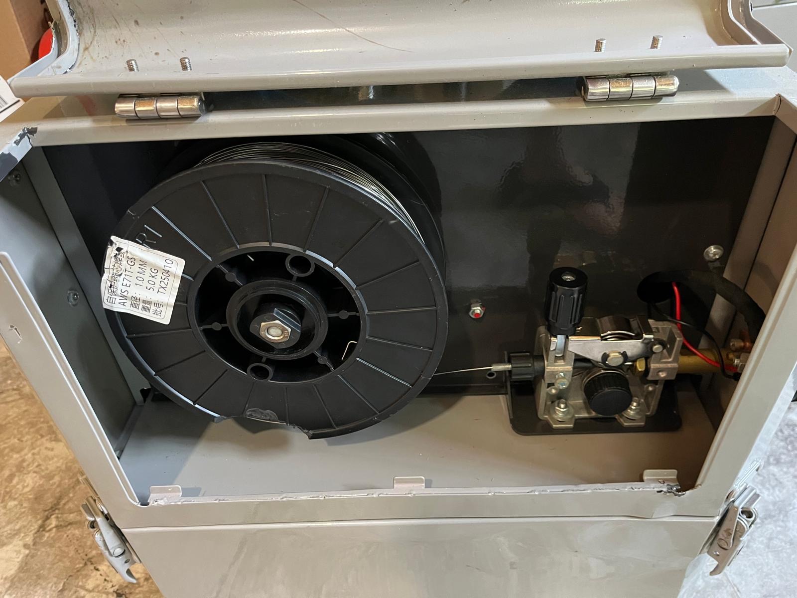 Quick Arc MIG wire spool compartment